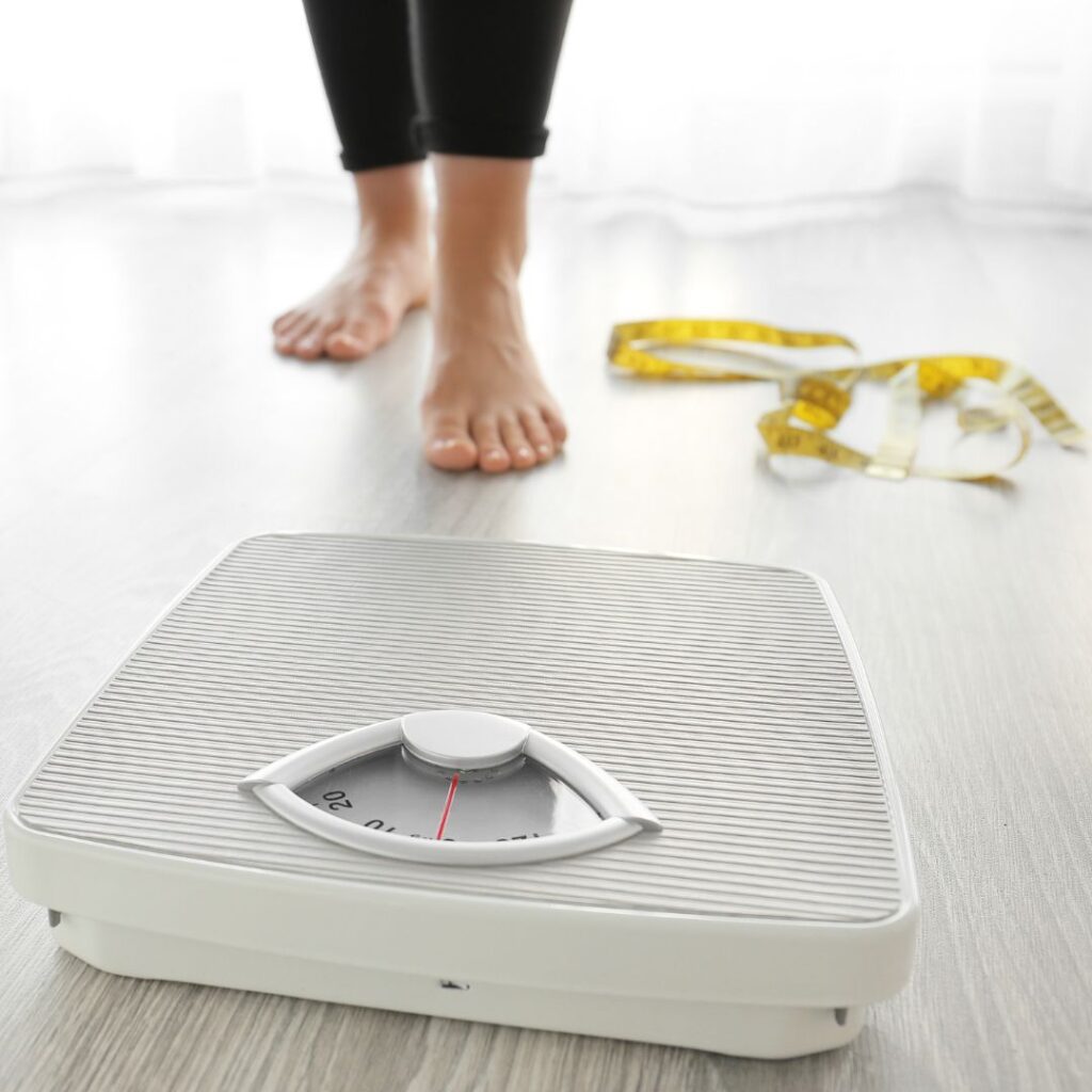 Person preparing to step on a scale.